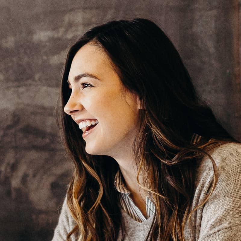 A woman is smiling while sitting at a table in Los Angeles.